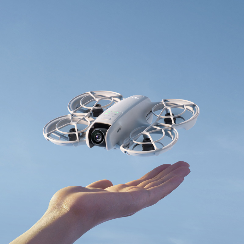 DJI Neo drone hovering above a hand