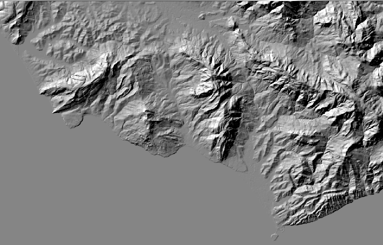 Hillshade visualization showing mountainous terrain with simulated sunlight creating shadows and highlights